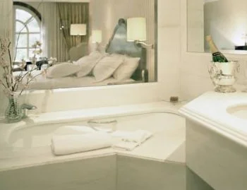 Interior de la Suite Deluxe con vistas al parque y cama extragrande donde encontrarás un jacuzzi para relajarte con tu pareja.
