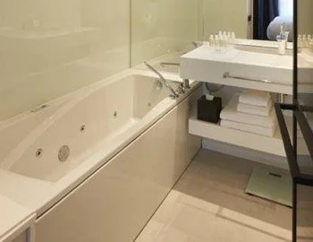 Vista del interior de la Suite Junior con vistas a la ciudad en donde puedes disfrutar con tu pareja de tu propia bañera de hidromasaje.
