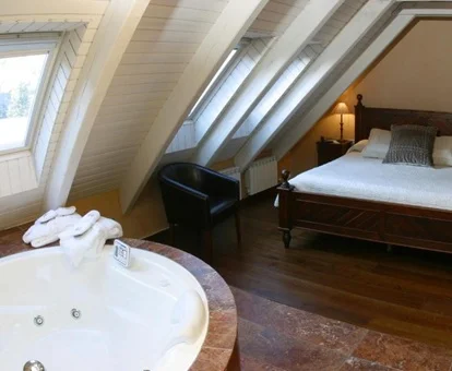jacuzzi circular para dos personas enfrente de la cama en la suite con bañera de hidromasaje decorada en estilo rústico del Hotel & Spa Casa Irene