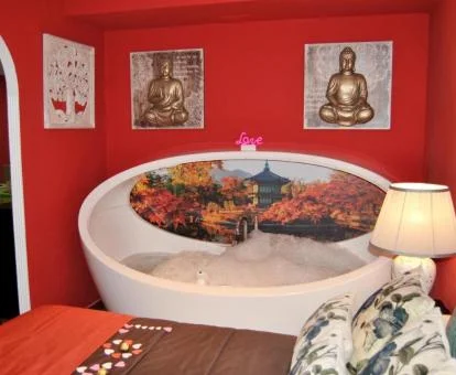 Coqueta bañera de hidromasaje junto a la cama de este apartamento ideal para parejas.