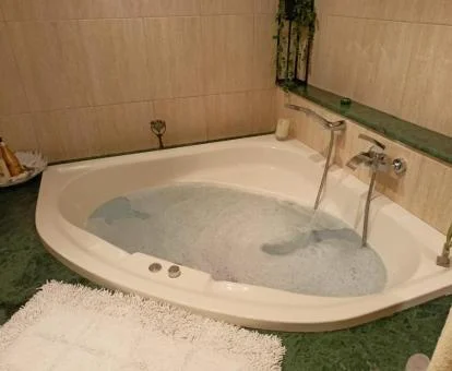 Amplia bañera de hidromasaje privada en uno de los baños del apartamento.