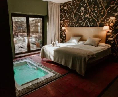 Una de las preciosas habitaciones con jacuzzi privado junto a la cama del hotel.