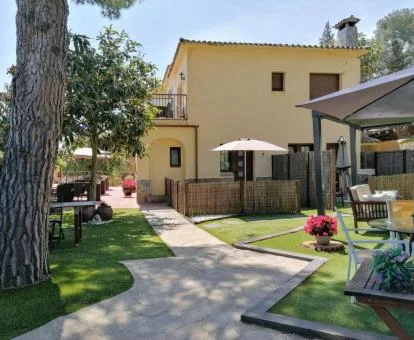 Hotel boutique con agradable zona exterior ajardinada y mobiliario.