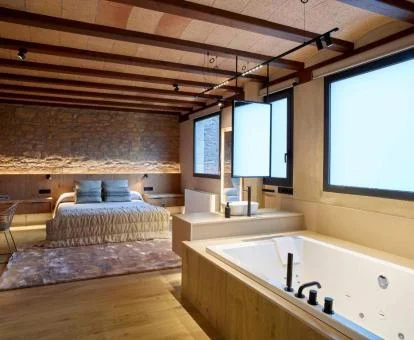 Precioso dormitorio con bañera de hidromasaje privada cerca de la cama.