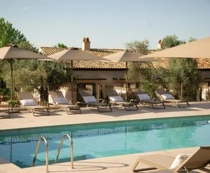 Hermosa zona exterior con piscina y tumbonas de este hotel boutique.