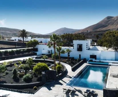 Hermoso hotel boutique con jardín de tipo volcánico y piscina exterior.