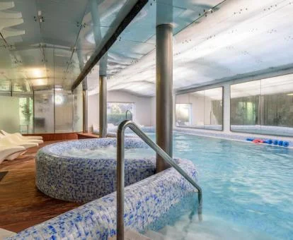 Piscina cubierta con elementos de hidroterapia del spa del hotel.
