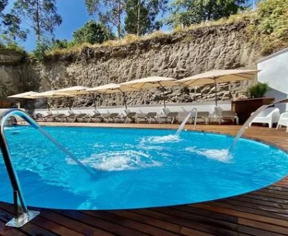 Piscina con elementos de hidroterapia al aire libre del hotel.