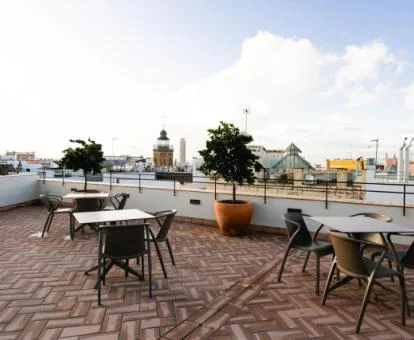 Terraza con mobiliario y vistas a la ciudad de este hotel boutique.