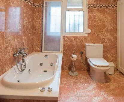 Baño con bañera de hidromasaje privada de este acogedor apartamento estudio.