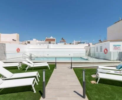 Terraza solarium con tumbonas y piscina de este hotel boutique.