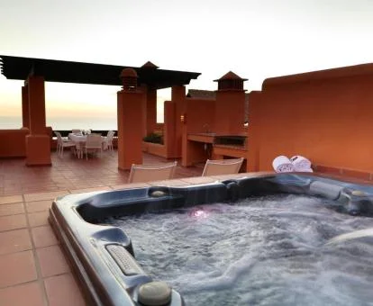 Amplia terraza con jacuzzi privado de uno de los apartamentos de este establecimiento.