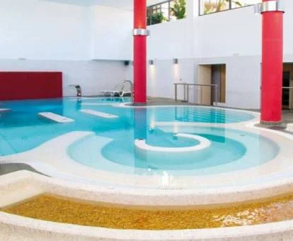 Piscina cubierta con elementos de hidroterapia del spa del hotel.