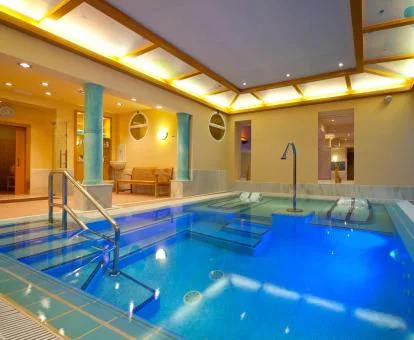 Piscina cubierta con elementos de hidroterapia del spa del hotel.