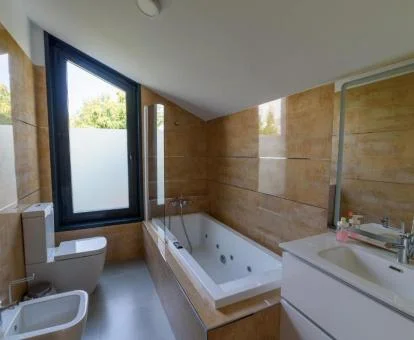 Amplio baño con bañera de hidromasaje privada de uno de los apartamentos de dos dormitorios del establecimiento.