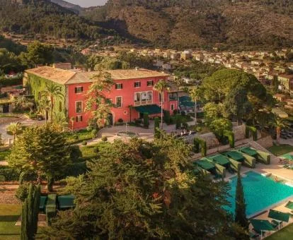 Vista aérea de este hermoso hotel boutique rodeado de jardines con piscina al aire libre.