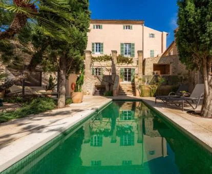 Hotel con encanto con piscina exterior y zona de estar al aire libre.